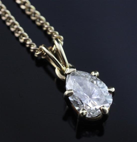 A gold and pear shaped diamond pendant, on a 9ct gold fine curb link chain, pendant 12mm.